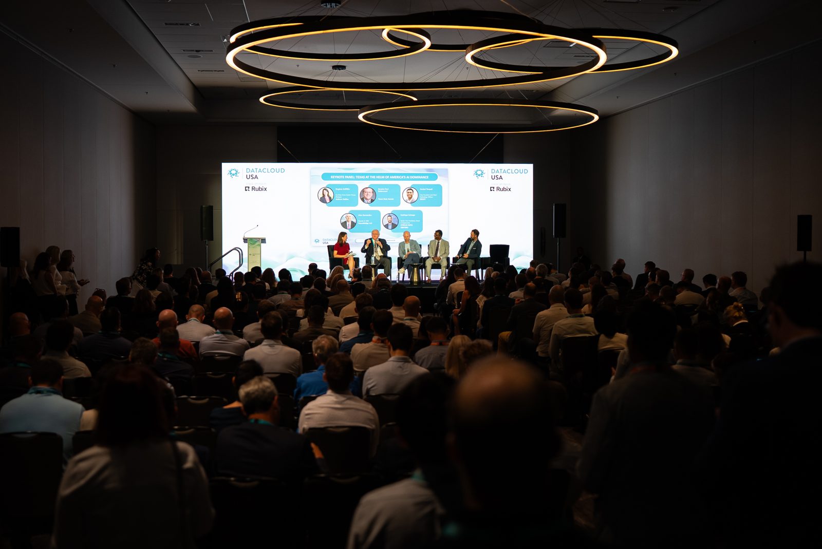 Wide view of the Datacloud USA ballroom with a full audience facing the main stage