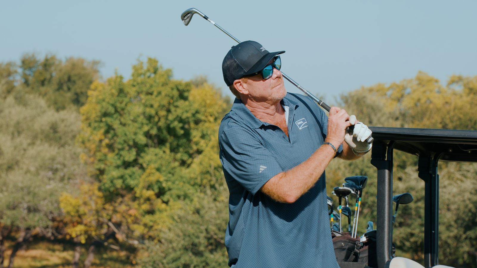 Golfer mid swing at Avery Ranch, frame from the golf day recap